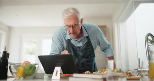 Mature Man Preparing Meal in Bright Kitchen