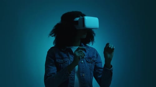 Woman Uses VR Headset in a Blue Studio