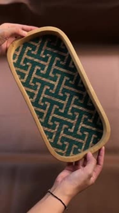 Hands Displaying Decorative Wooden Tray in Portrait Orientation