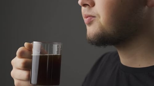 Close-up of thoughtful man drinking coffee.