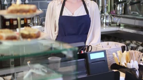 MS TU Mid adult woman standing in kitchen of cafe and smiling