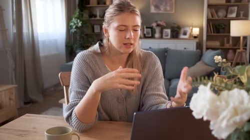 Woman Chatting on Laptop at Home
