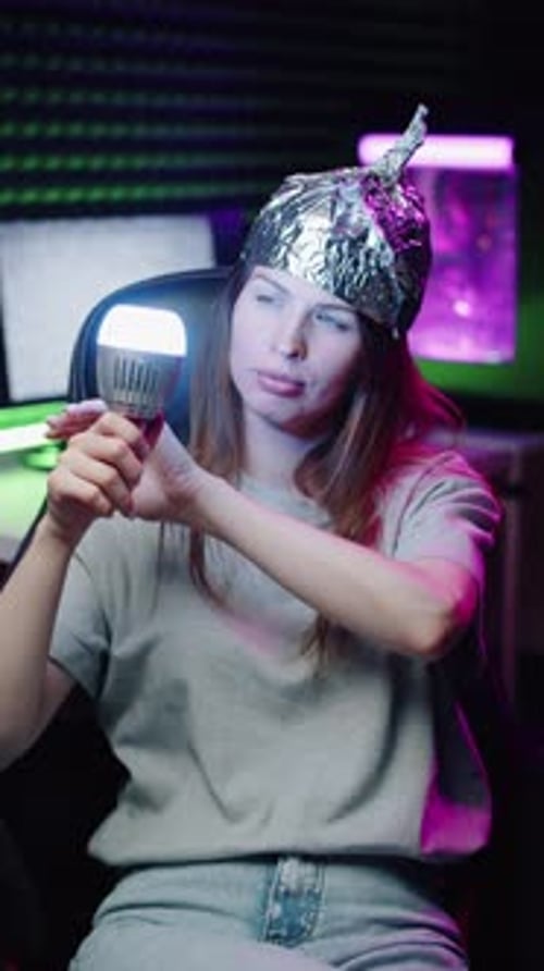 Woman in Foil Hat Changing Bulb Color with Hand Motion