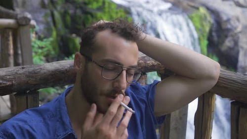 Un homme stressé fume. Dépendance au tabac