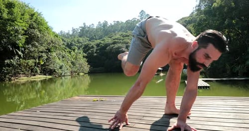 Person exercising outdoors, man stretching boy by deck