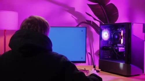 Computer with Chroma Key Green Screen on Monitor Gamer Man Playing in Popular Video Games Programmer