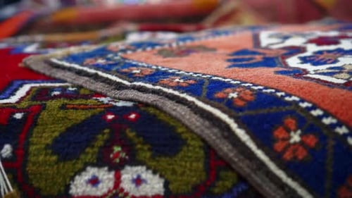 Pan left Colorful rugs and carpets in old bazaar of Kayseri, Turkey Silk Road