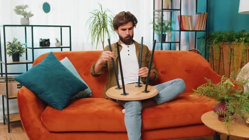 Man Assembles Small Table at Home