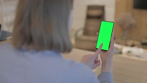 Young Woman Using Phone with Green Screen