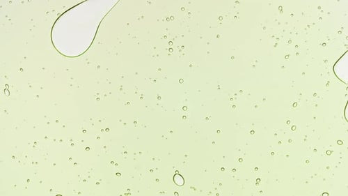 Transparent Green Cosmetic Gel Fluid With Molecule Bubbles and Oil on White Background Macro Shot