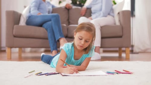 Girl Draws with Pencils in Living Room