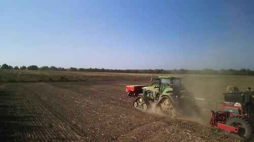 Tractor on the field seeding wheat