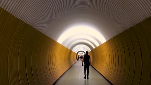 Slowmotion view of people passing the Brunkerg tunnel in Stockholm, Sweden