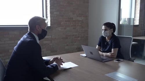 Business Meeting at Table with Laptop in Office