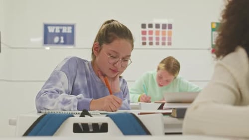 Students Working at Desks in Classroom