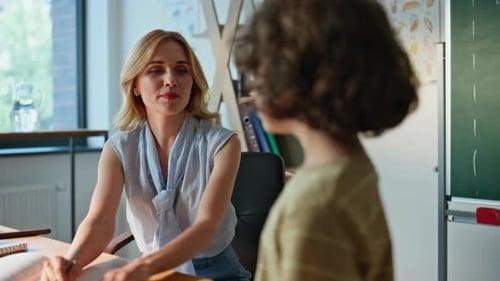 Teacher Meeting with Student in Classroom