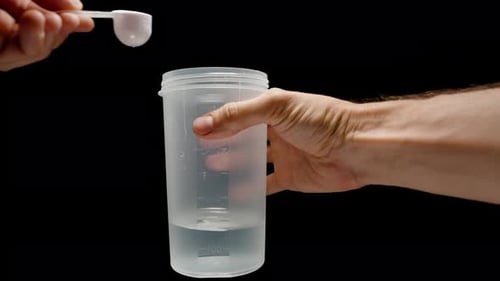 Adding Pink Powder to Water for Health Drink