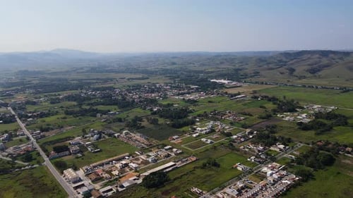 Aerial view of a small town in the countryside with few houses and lots of green space available for