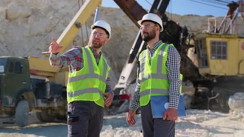 Construction Workers Engineers are Talking at the Quarry Mining Site
