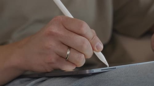 Woman Drawing on a Tablet with Stylus Pen