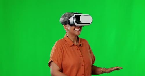 Virtual reality, technology and woman in studio with green screen playing a video game with headset