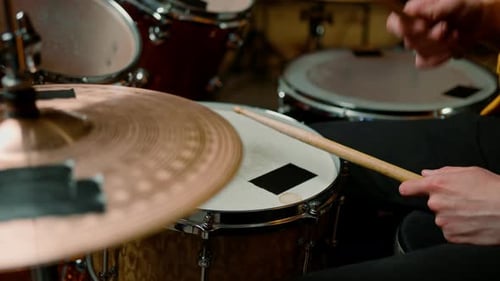 drummer plays a drum kit in a recording studio at a professional musician rehearsal recording a song