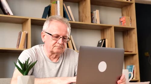 Mature Adult Using Laptop at Home Inside