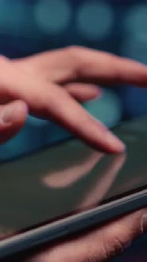 Hand using a digital tablet with code
