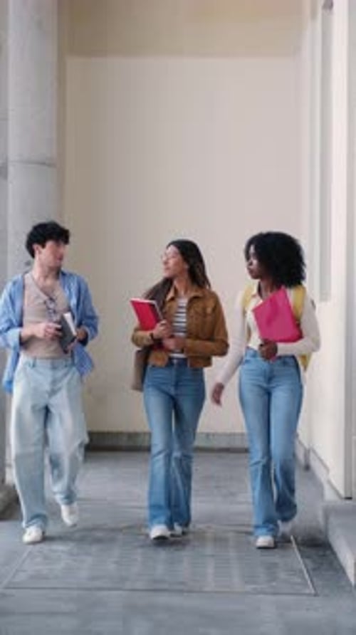 Diverse students walking together at university campus
