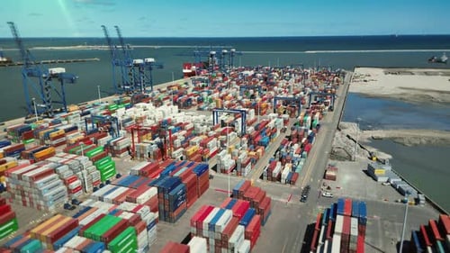 Aerial view of a commercial seaport. Cargo containers are stacked in stacks.