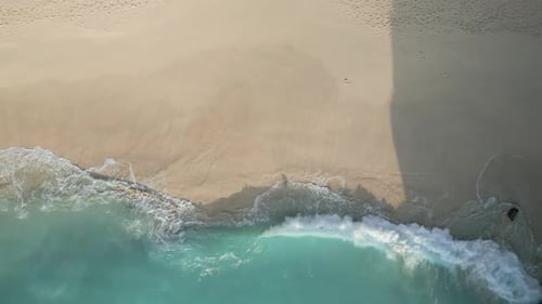 Aerial View of Waves Crashing on Beach