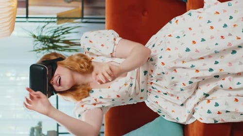 Woman Experiencing Virtual Reality While Lying on Sofa