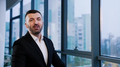 Professional Businessman Speaking to Camera in Urban Office