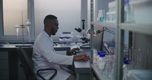 Scientist Working on Computer in Modern Lab