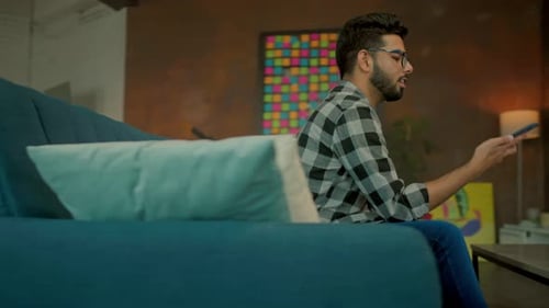 Man Using Smartphone in Modern Living Room
