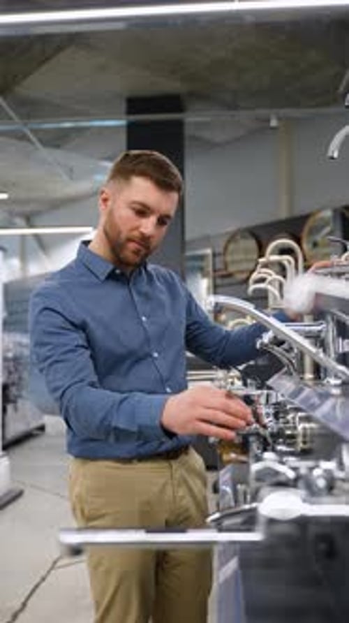 Handsome Man Chooses a Water Tap in Plumbing Store Vertical Video