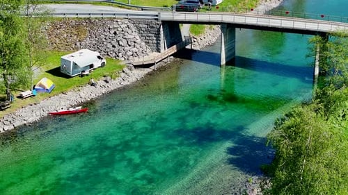 RV Camping by a Bridge With Crystal Clear Water