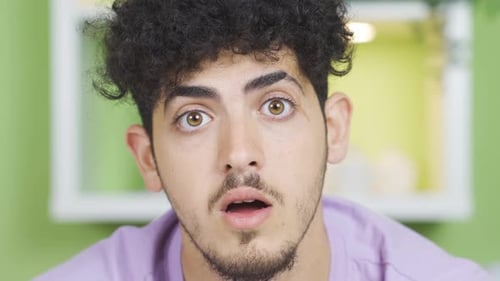 Young Adult Reacting to Something With Surprise