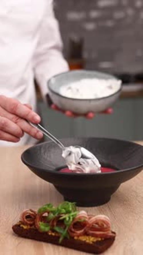 The chef is preparing a puree soup in the kitchen. Close-up