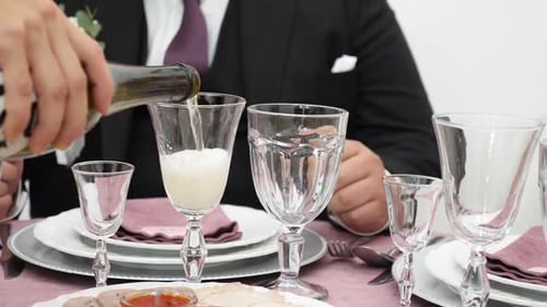 155s. A glass of sparkling champagne on the festive table.