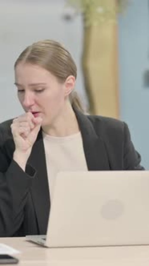 Business Woman Coughing in Office at Her Desk