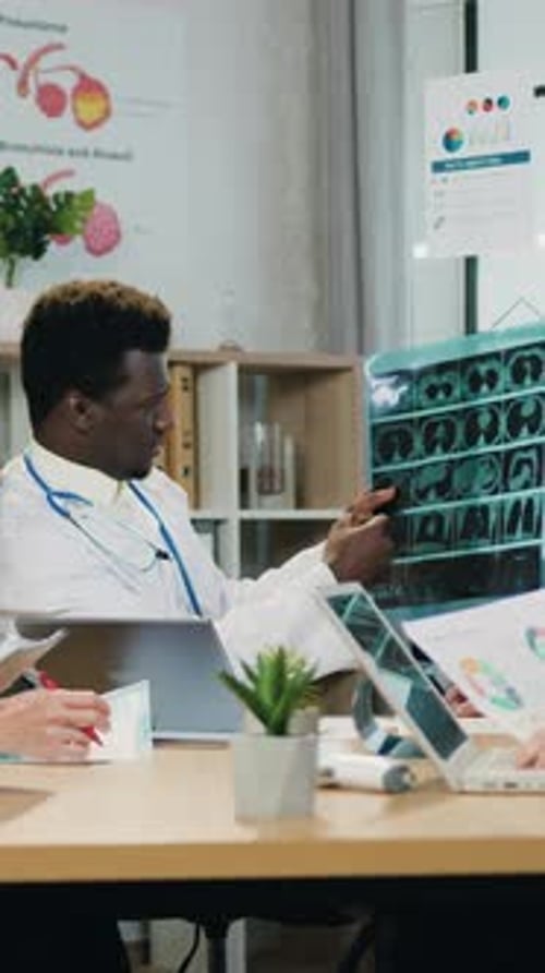 Doctor Explains Scan Results in Brightly Lit Office