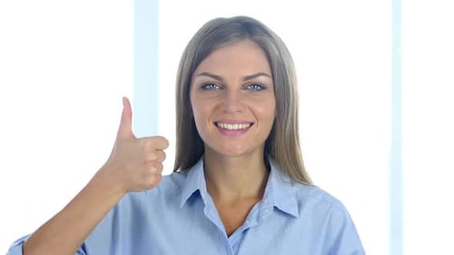 Woman Gives Thumbs Up in Studio Setting