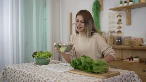 Woman Prepares Healthy Salad in Bright Kitchen