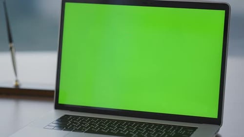 Modern Green Screen Laptop Placed on Office Desk Close Up. View Of