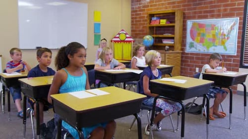 Elementary School Students Raise Hands in Classroom 5-6