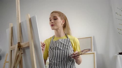 Young Adult Female Artist Drawing Picture By Oil Dyes in Art Studio Portrait Professional Painter or