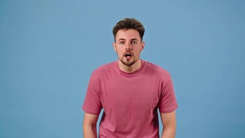 Excited Man Celebrating Success Against Blue Background