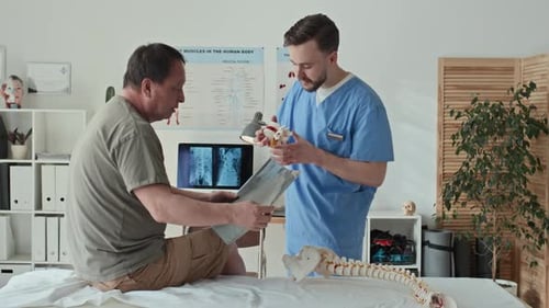 Therapist Explaining the Problem with Spine to Patient