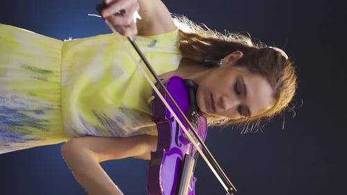 Woman Performing on Shiny Purple Violin